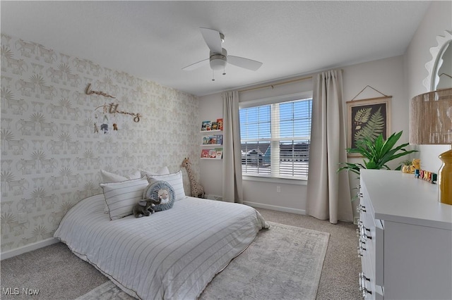 carpeted bedroom featuring a textured ceiling and ceiling fan