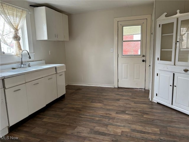 kitchen with sink, dark wood-type flooring, and white cabinets