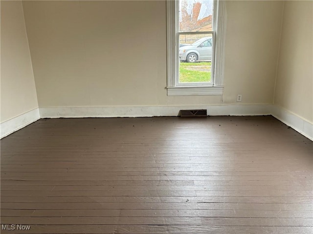 spare room with dark wood-type flooring