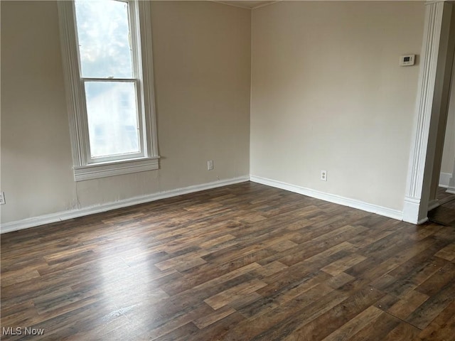 empty room with dark wood-type flooring