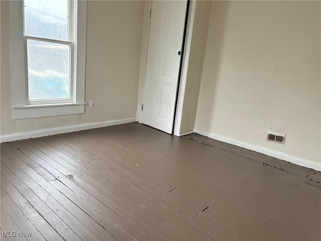 spare room featuring dark hardwood / wood-style flooring