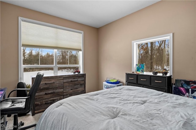 bedroom featuring light carpet