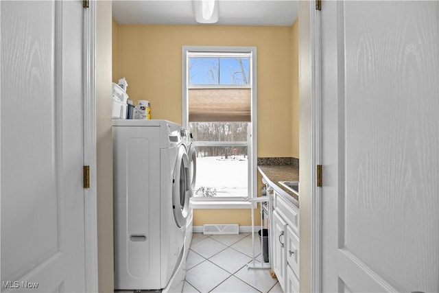 washroom with light tile patterned floors and washing machine and clothes dryer