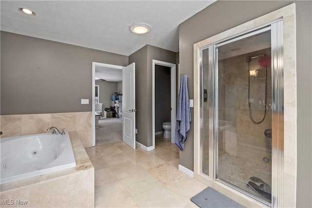 bathroom featuring tile patterned floors, toilet, and separate shower and tub