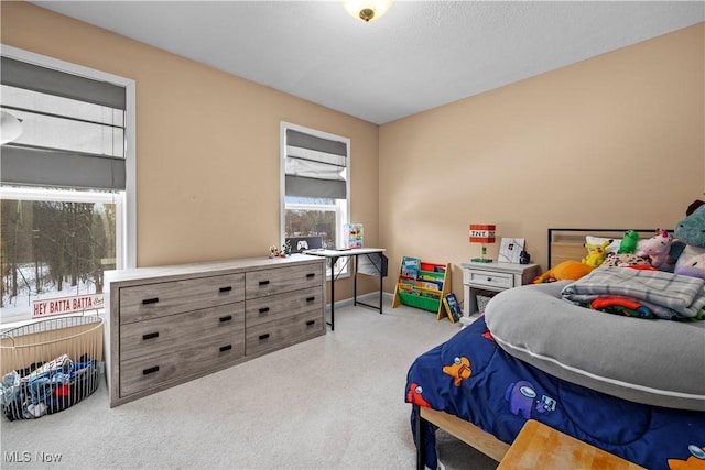 bedroom featuring light colored carpet