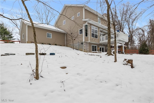 snow covered house with a deck