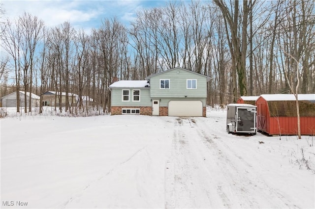 view of front of property with a shed and a garage