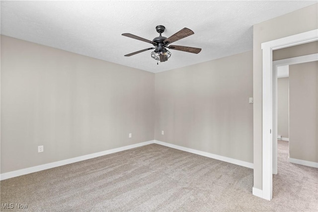 carpeted empty room with ceiling fan and a textured ceiling