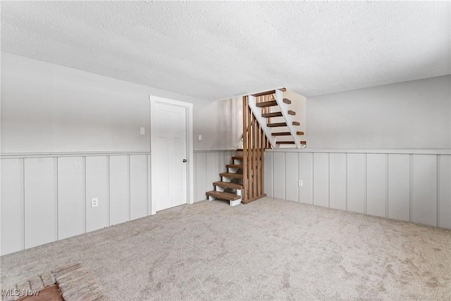 interior space with carpet floors and a textured ceiling