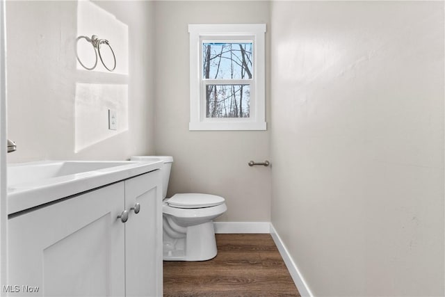 bathroom with vanity, hardwood / wood-style floors, and toilet