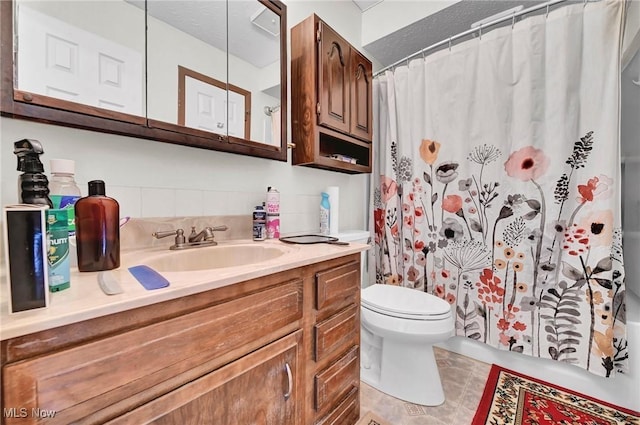 bathroom featuring vanity, curtained shower, and toilet