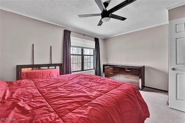 bedroom featuring ceiling fan, carpet floors, and a textured ceiling