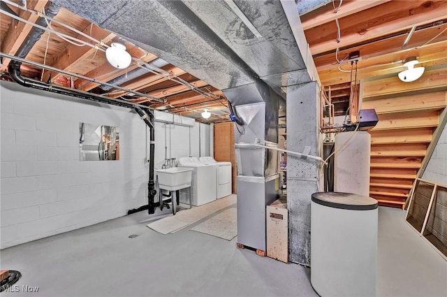 basement featuring washing machine and clothes dryer and sink