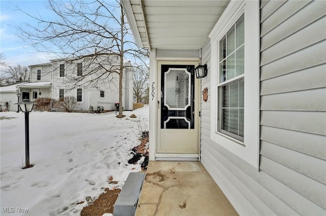 view of snow covered property entrance