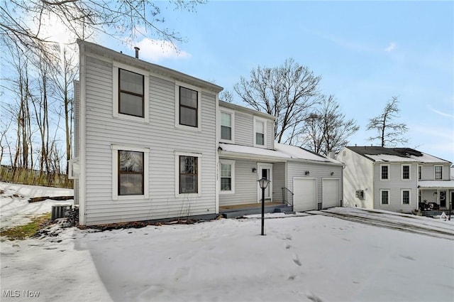 view of front facade featuring a garage and central AC