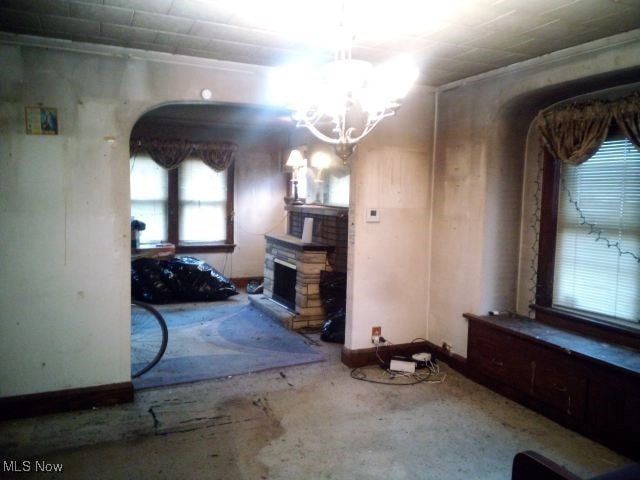 unfurnished living room with a notable chandelier