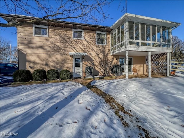 view of front of house featuring a sunroom