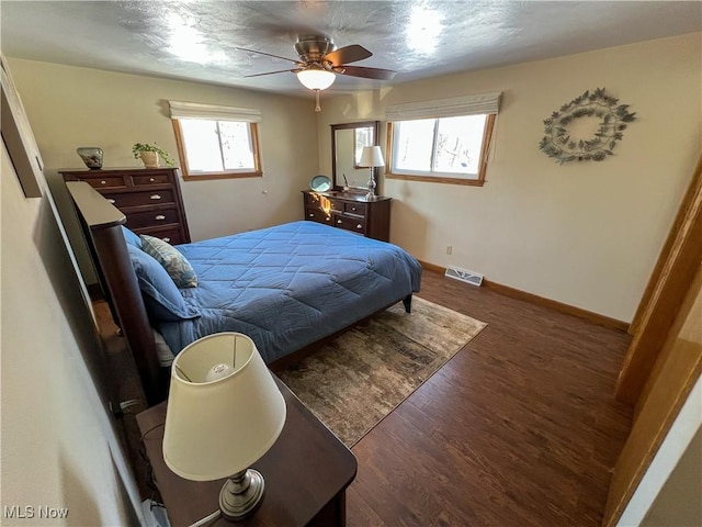 bedroom with ceiling fan and dark hardwood / wood-style flooring