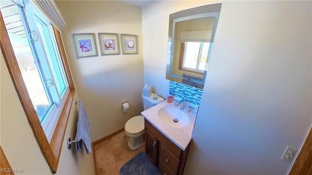 bathroom featuring vanity and toilet