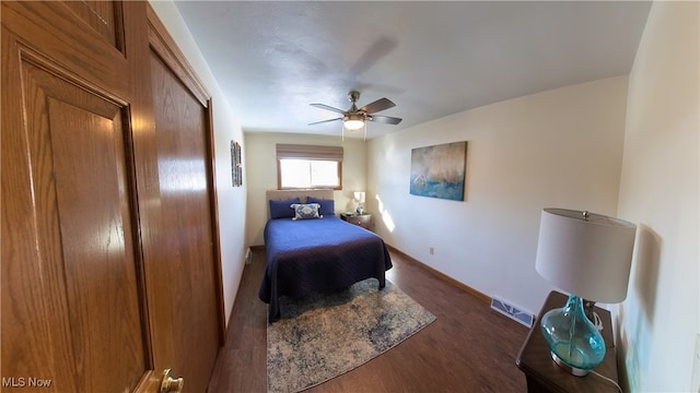 bedroom with dark hardwood / wood-style floors and ceiling fan