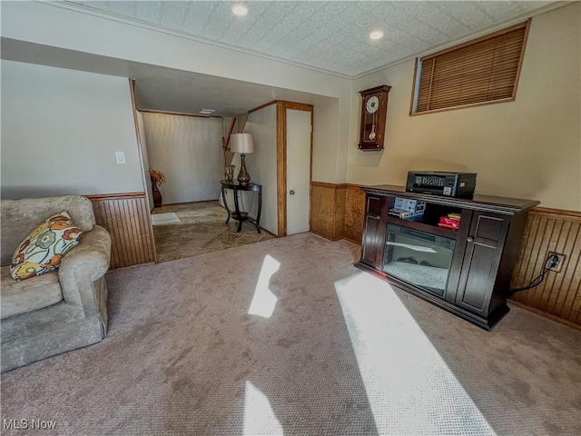 living room featuring light colored carpet and wood walls