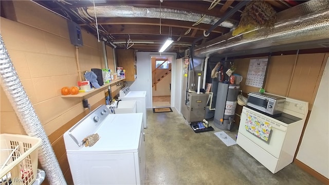 basement featuring water heater, separate washer and dryer, and heating unit