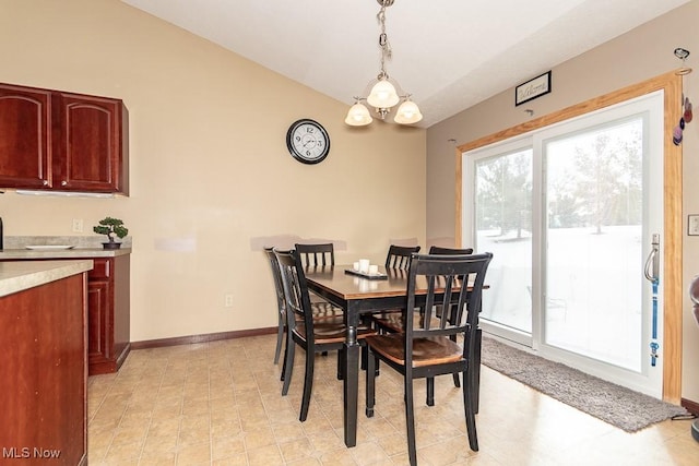 dining space featuring vaulted ceiling