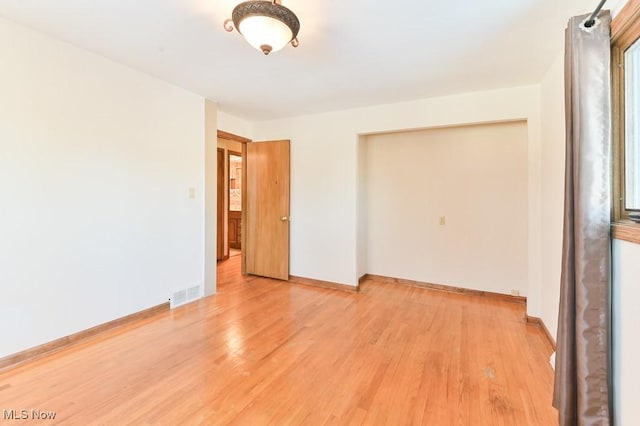 unfurnished room featuring light hardwood / wood-style flooring