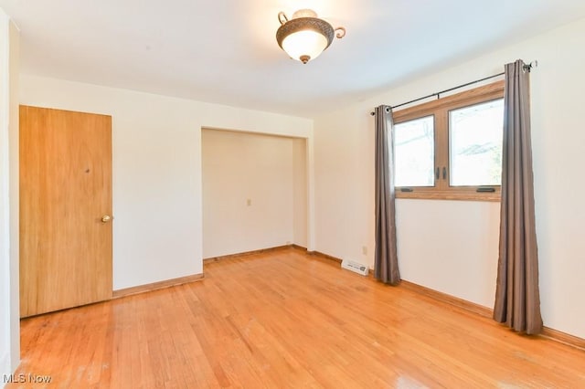 unfurnished room featuring hardwood / wood-style floors