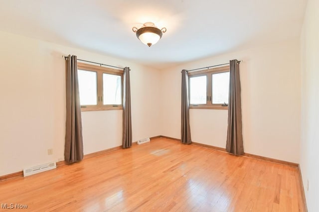 spare room featuring wood-type flooring