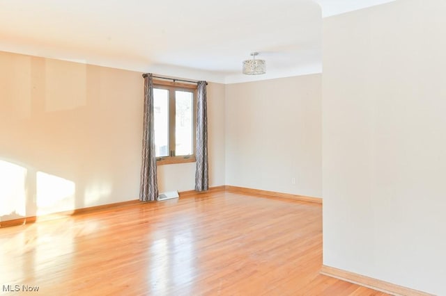 spare room featuring wood-type flooring