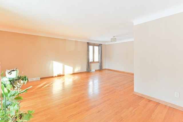 spare room with light hardwood / wood-style floors