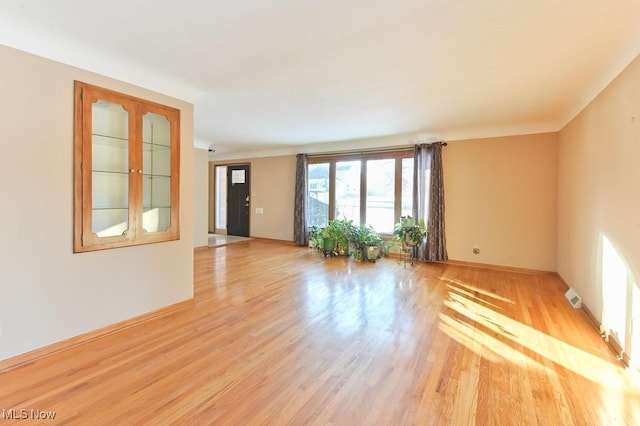 unfurnished room with light hardwood / wood-style flooring