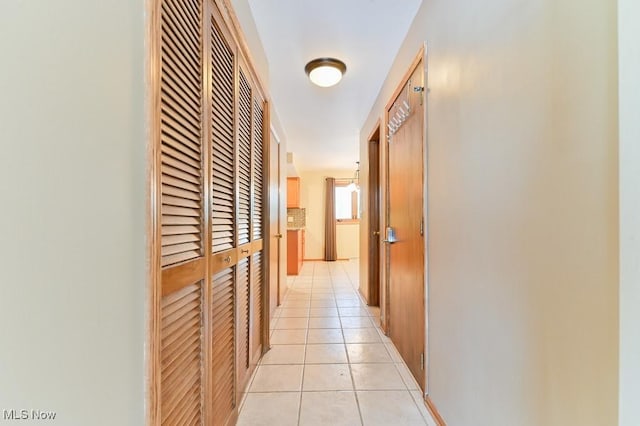 hall with light tile patterned floors