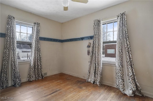 unfurnished room featuring hardwood / wood-style flooring and ceiling fan