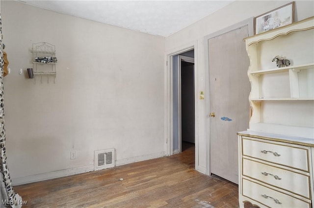 empty room with dark hardwood / wood-style flooring