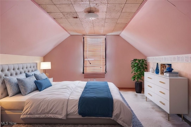 bedroom featuring lofted ceiling and light carpet