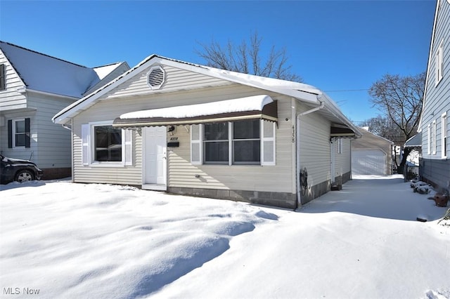 view of front facade with a garage and an outbuilding