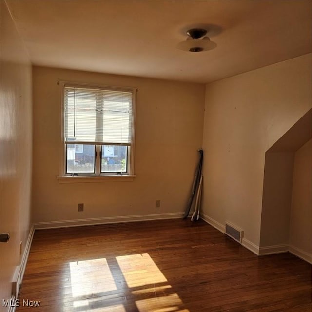 empty room with dark wood-type flooring