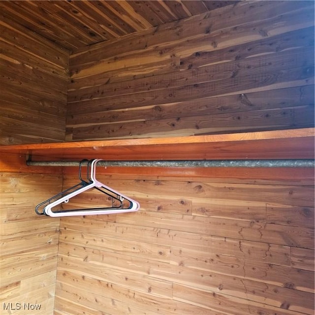 interior details featuring wooden ceiling and wood walls