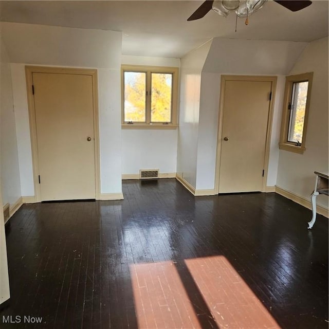 spare room with ceiling fan, lofted ceiling, and dark hardwood / wood-style flooring