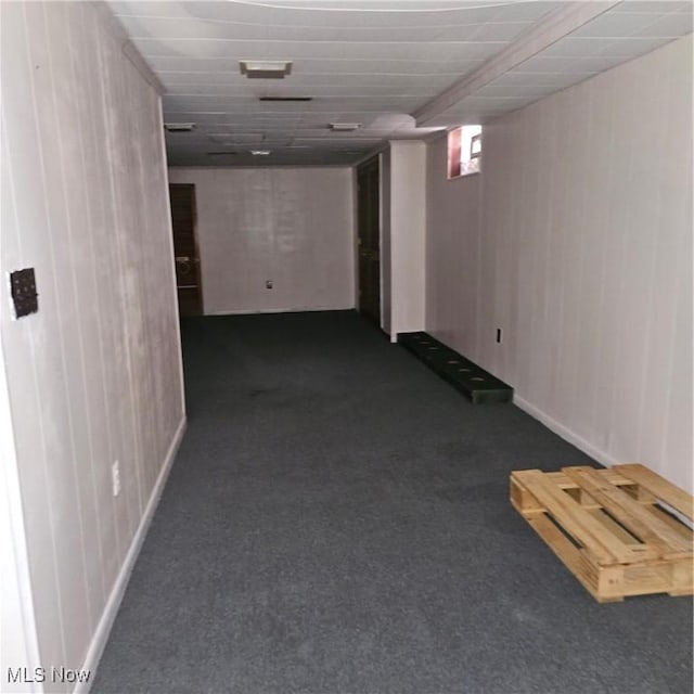 basement featuring dark colored carpet