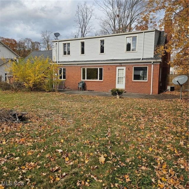 rear view of property with a yard and a patio