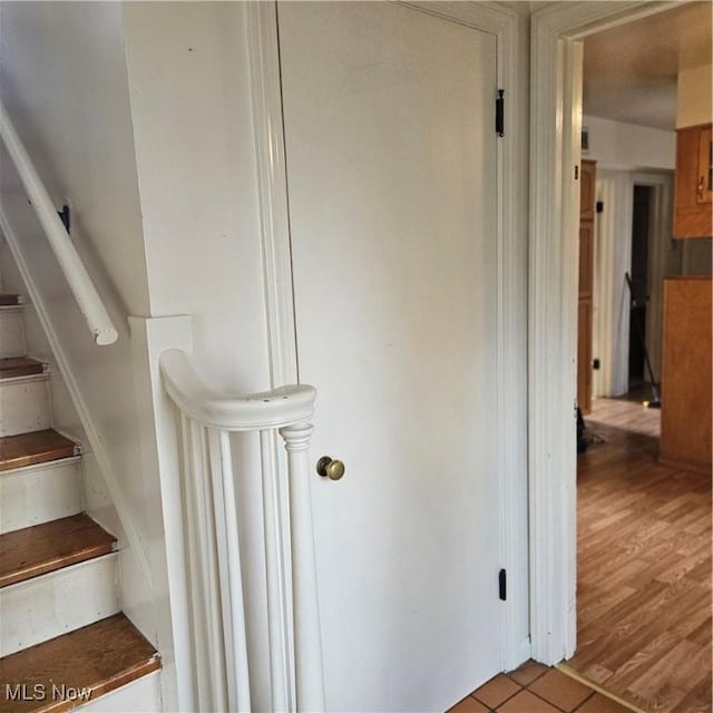 stairway featuring wood-type flooring