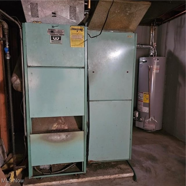 utility room with heating unit and water heater