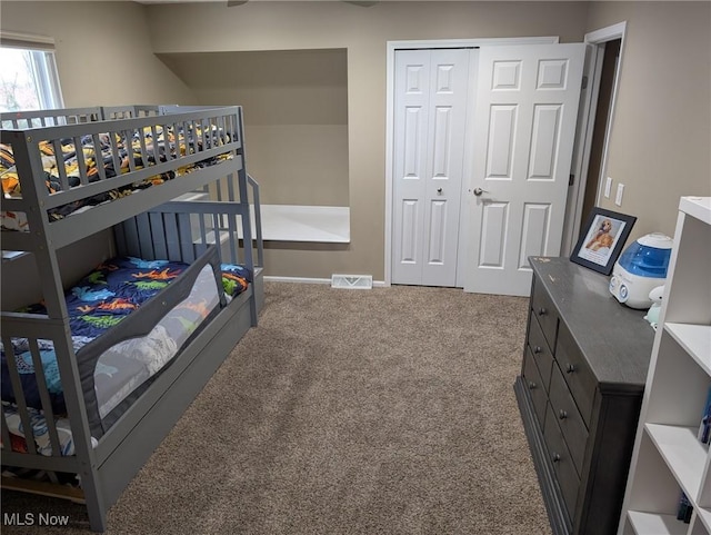 carpeted bedroom with a closet