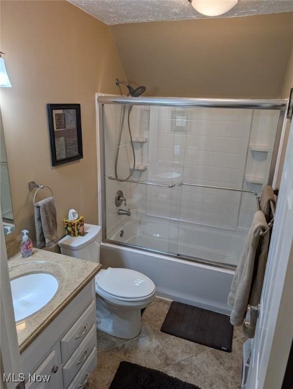 full bathroom featuring shower / bath combination with glass door, tile patterned flooring, vanity, toilet, and a textured ceiling