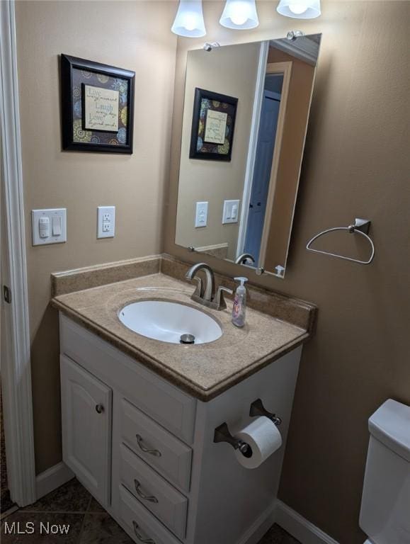 bathroom with vanity, toilet, and tile patterned flooring