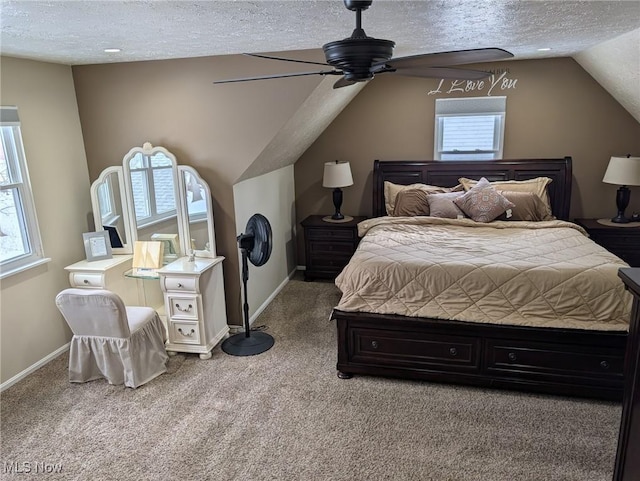 carpeted bedroom with multiple windows, ceiling fan, vaulted ceiling, and a textured ceiling