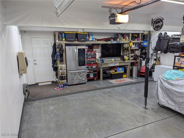 garage with a garage door opener and a workshop area